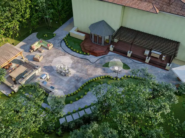 Terrasse de jardin avec coin salon, espace barbecue, parasols, lampe, végétation et arbres.