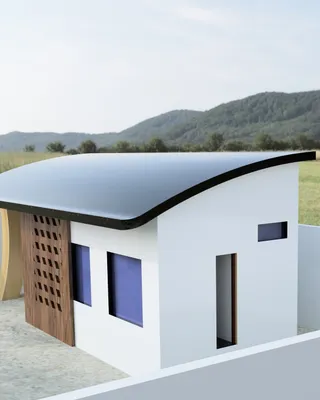 Modèle d'une petite maison moderne avec un toit incurvé dans un cadre rural avec des montagnes en arrière-plan.