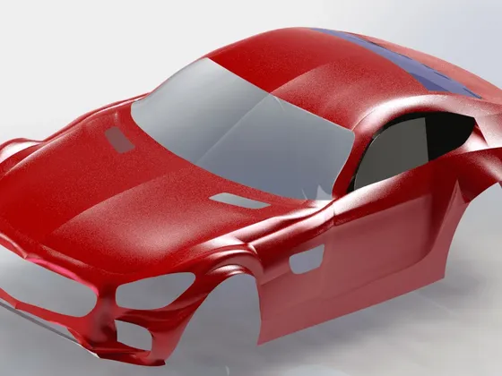 Modèle de voiture rouge avec une carrosserie futuriste et aérodynamique.