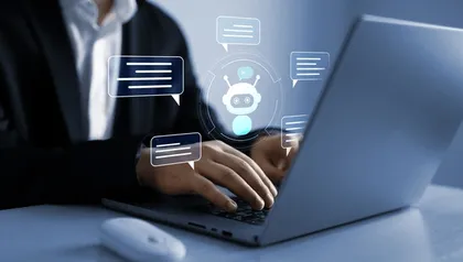 Une personne utilisant un ordinateur portable avec une icône de robot et des bulles de dialogue holographiques.